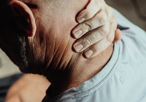 Patient clenching back of neck in pain