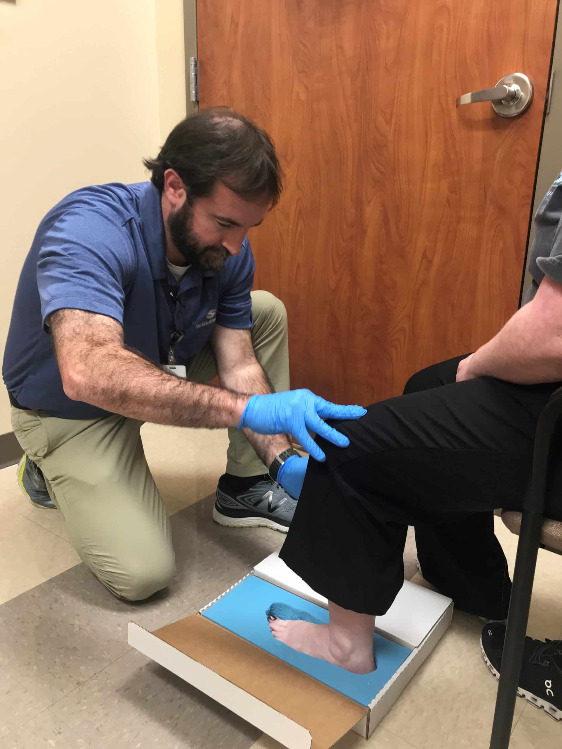 Southlake certified orthotist preparing custom orthotic shoes for patient with flat feet