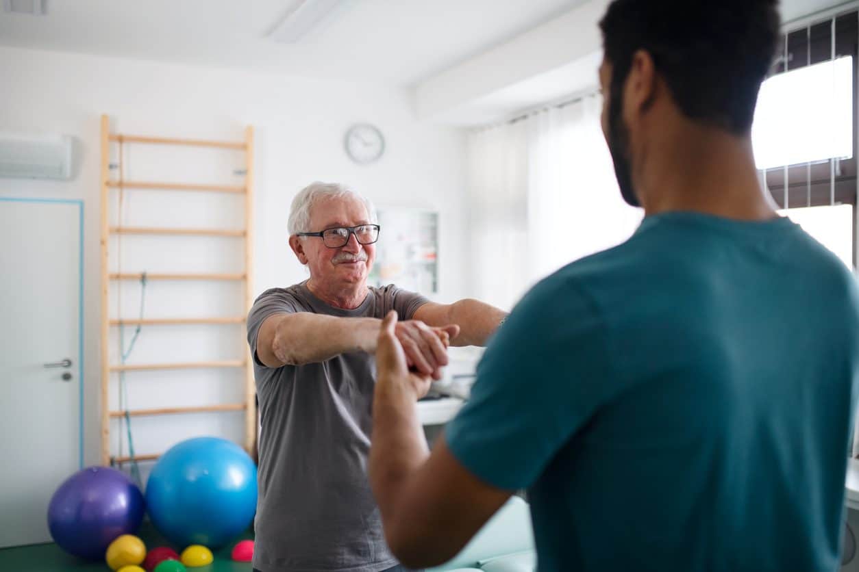 Patient performing exercises with physical therapist to treat cervical spondylosis