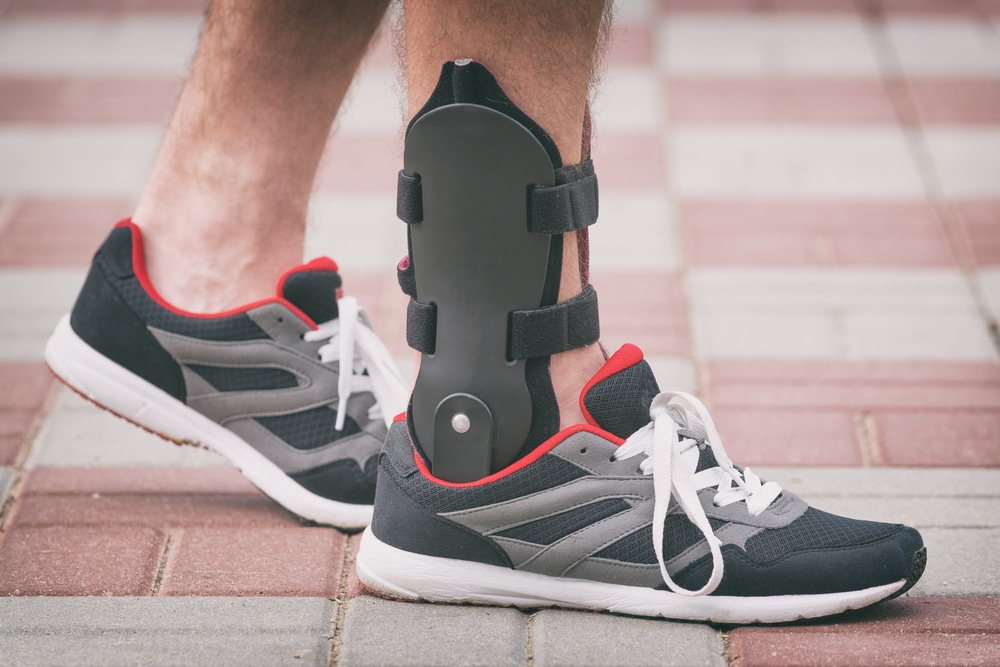 Patient with orthotic brace to help relieve pain from heel condition