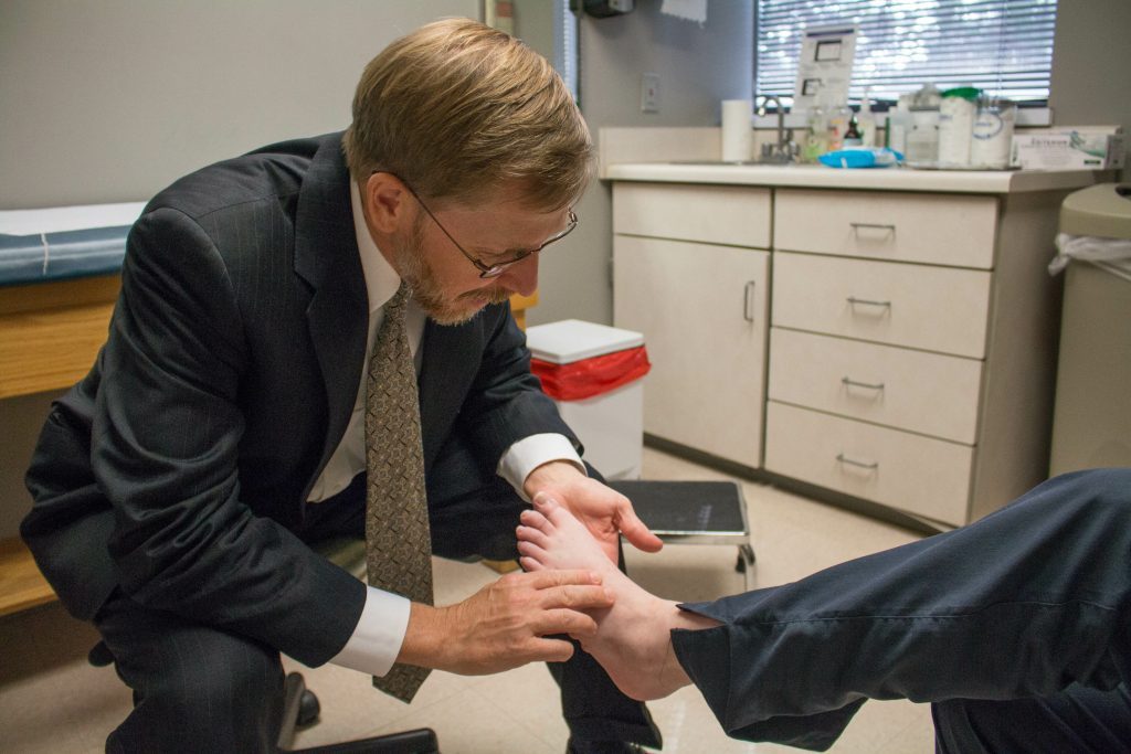 Southlake Orthopaedics’ Dr. John s. Kirchner, MD providing footcare by examining a patient’s bunion