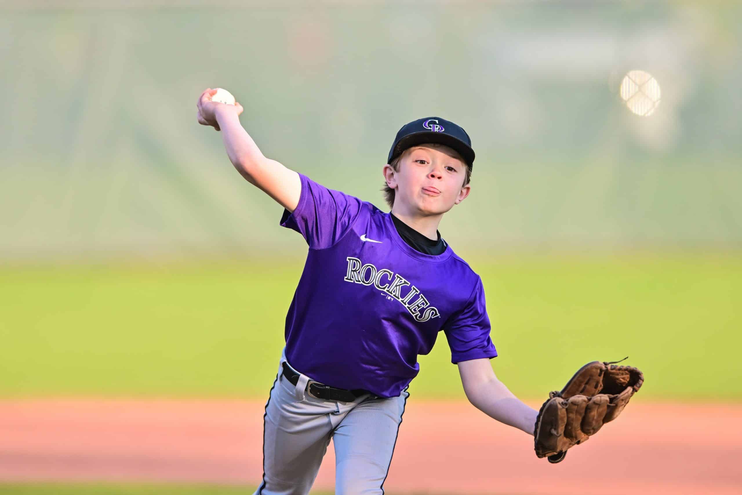 Youth-baseball-player-throwing-a-baseball-that-can-cause-little-league-elbow