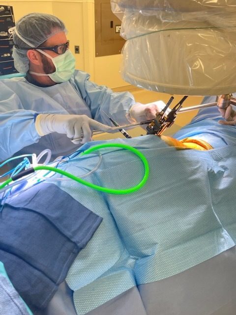 Dr. Christopher Heck, MD performing a spine procedure