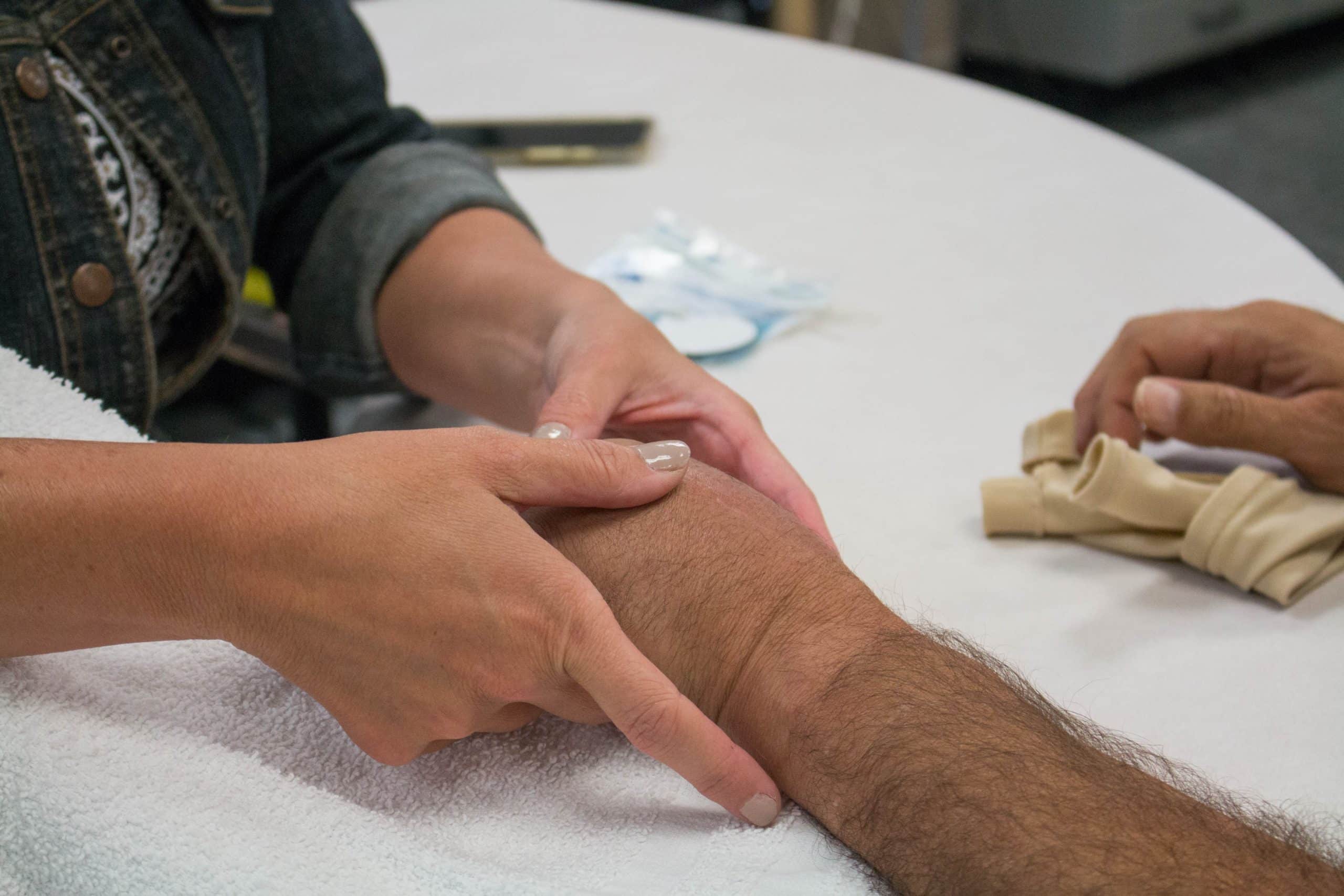 Hand physical therapist using techniques to relieve pain