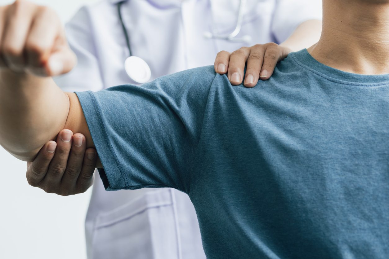 Doctor examining patient’s shoulder
