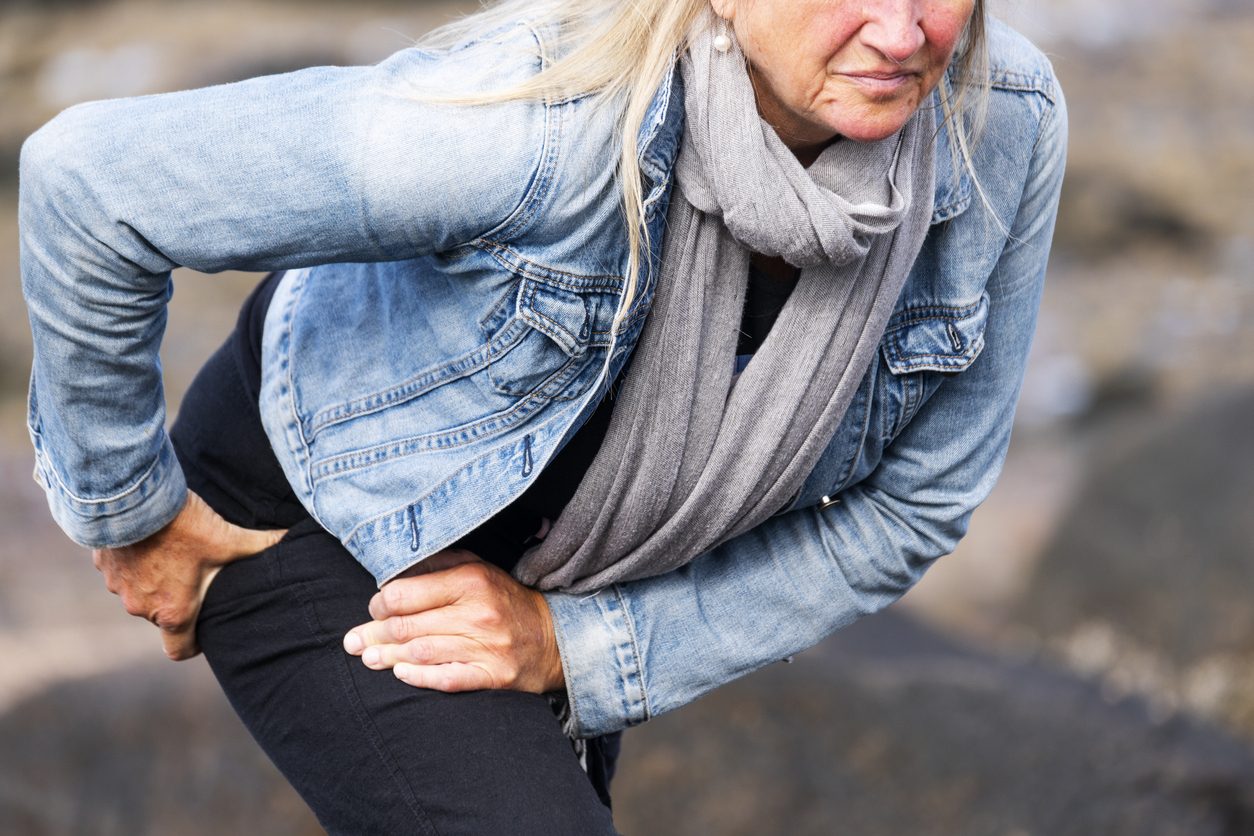 Patient holding hip in pain while walking