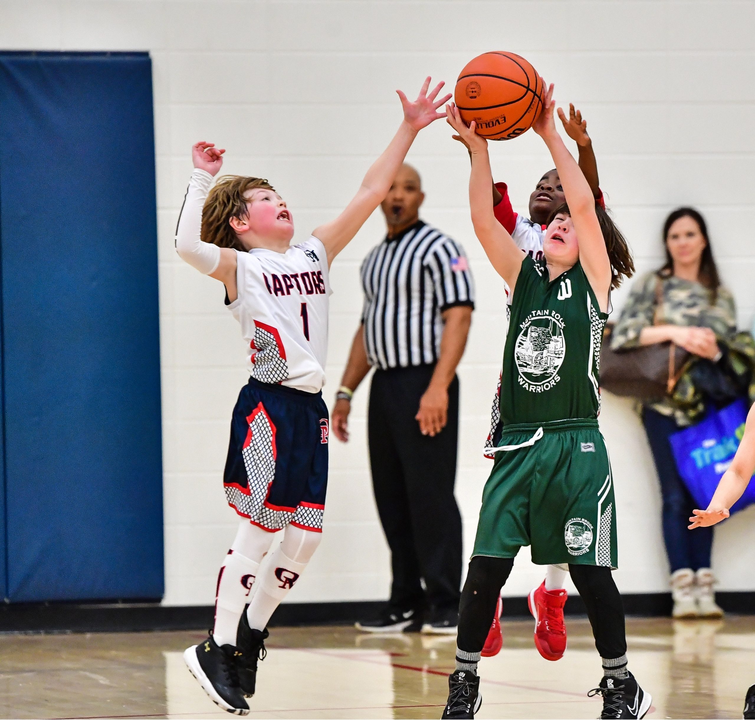 basketball players defending ball, which might lead to diagnosing a knee ligament injury