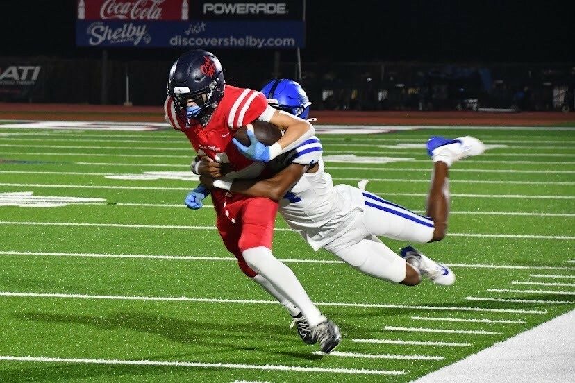 football player being tackled ball, which can lead to a knee ligament injury